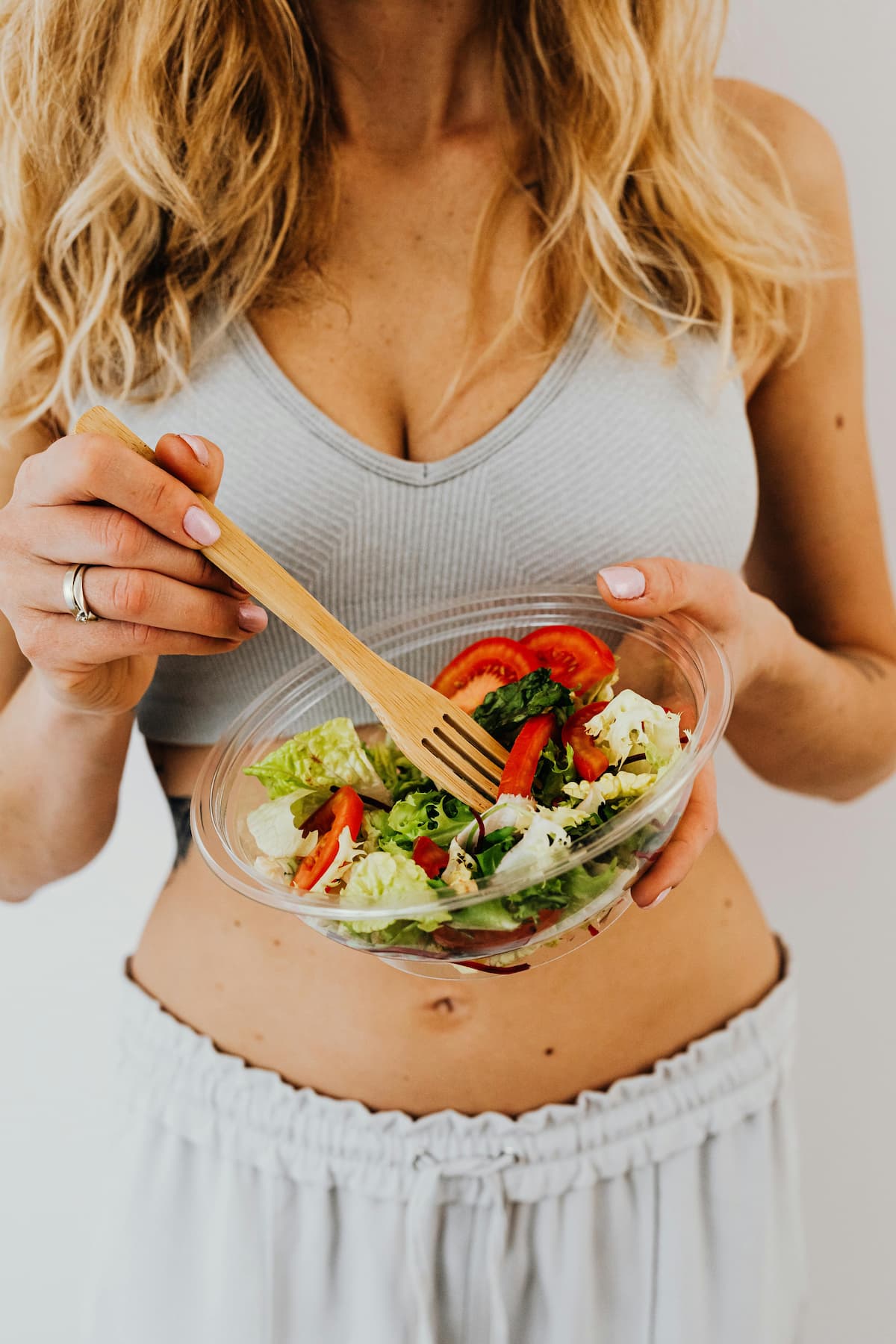 A fit woman holding a healthy bowl of food