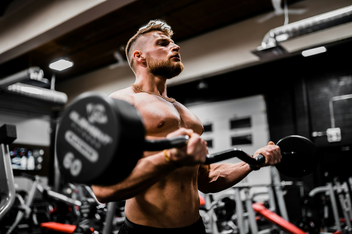 A muscular man doing a pull-up, representing muscle gain